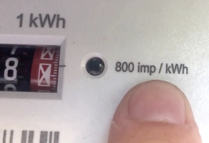 Close-up of a meter’s red light with the label 800 imp/kWh printed next to it
