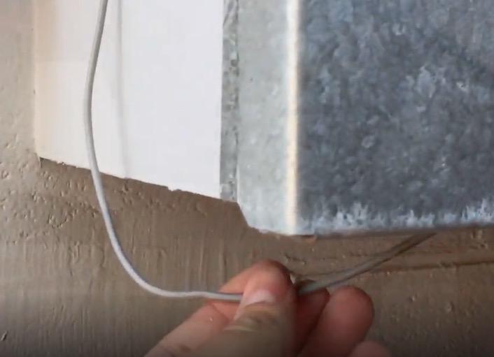 The sensor cable running down into the bottom of the meter box